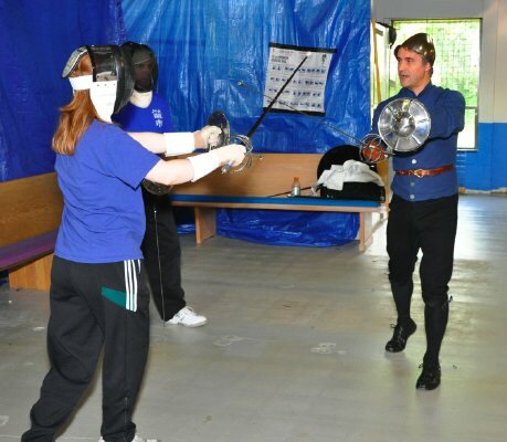 Two fencers prepare for a bout